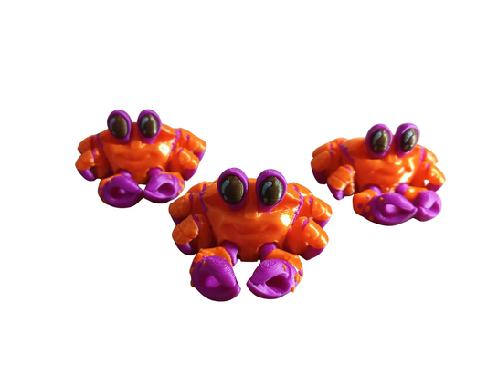 3D-printed articulated "Mini Crab" fidget toys designed by MatMire Makes.